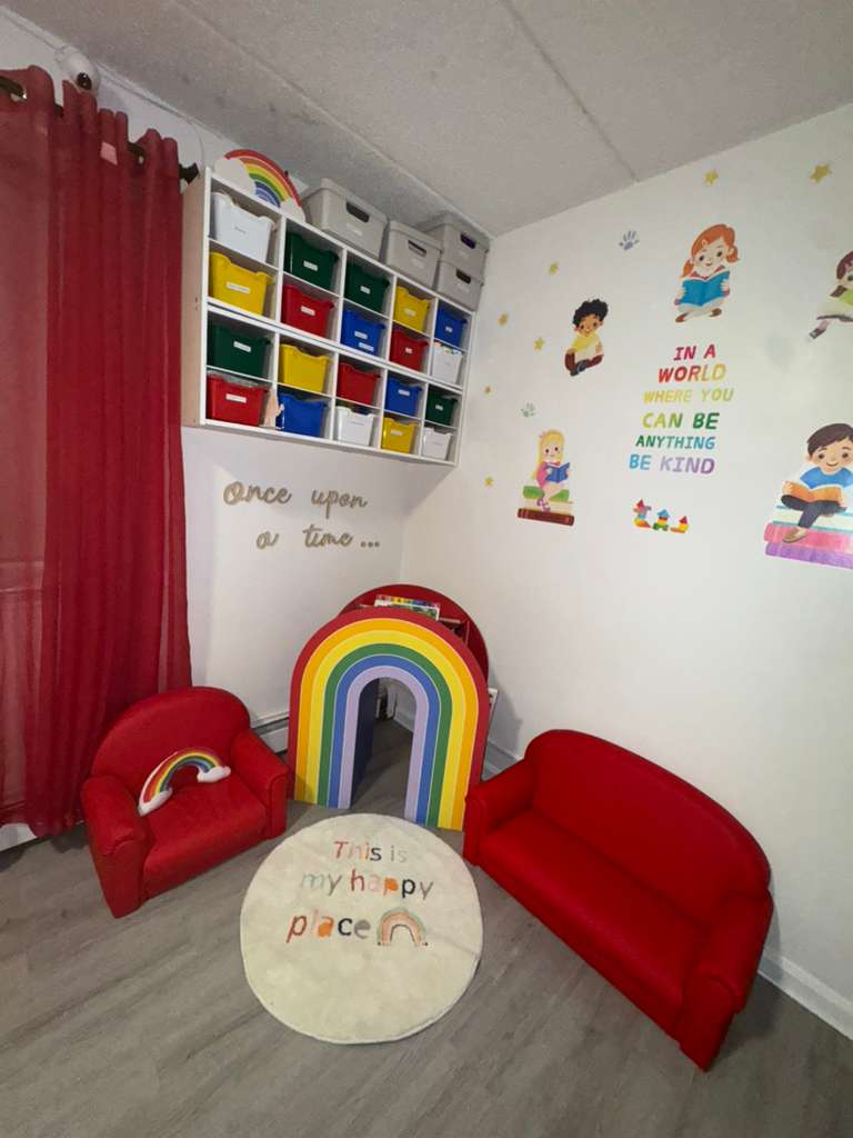 Cozy reading corner with rainbow decorations